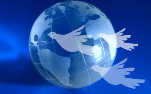 A blue globe with doves flying ahead. A global peace idea.